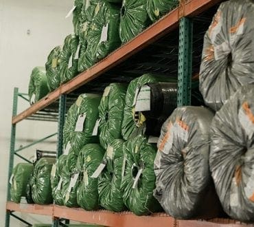 Synthetic turf on pallet racks