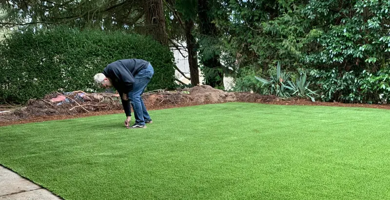 Removing weeds from artificial grass in Seattle, WA