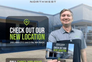 Synthetic Turf Northwest - New Fife, WA location open. Man holding a postcard that has the image of synthetic turf nw warehouse on it. INclude now open and the address. Phone number is 4257880718