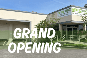 synthetic Turf Northwest Grand Opening at the new Fife, WA location. Image shows "Grand Opening" infront of the warehouse that has a sign on the building that says "Synthetic Turf Northwest"