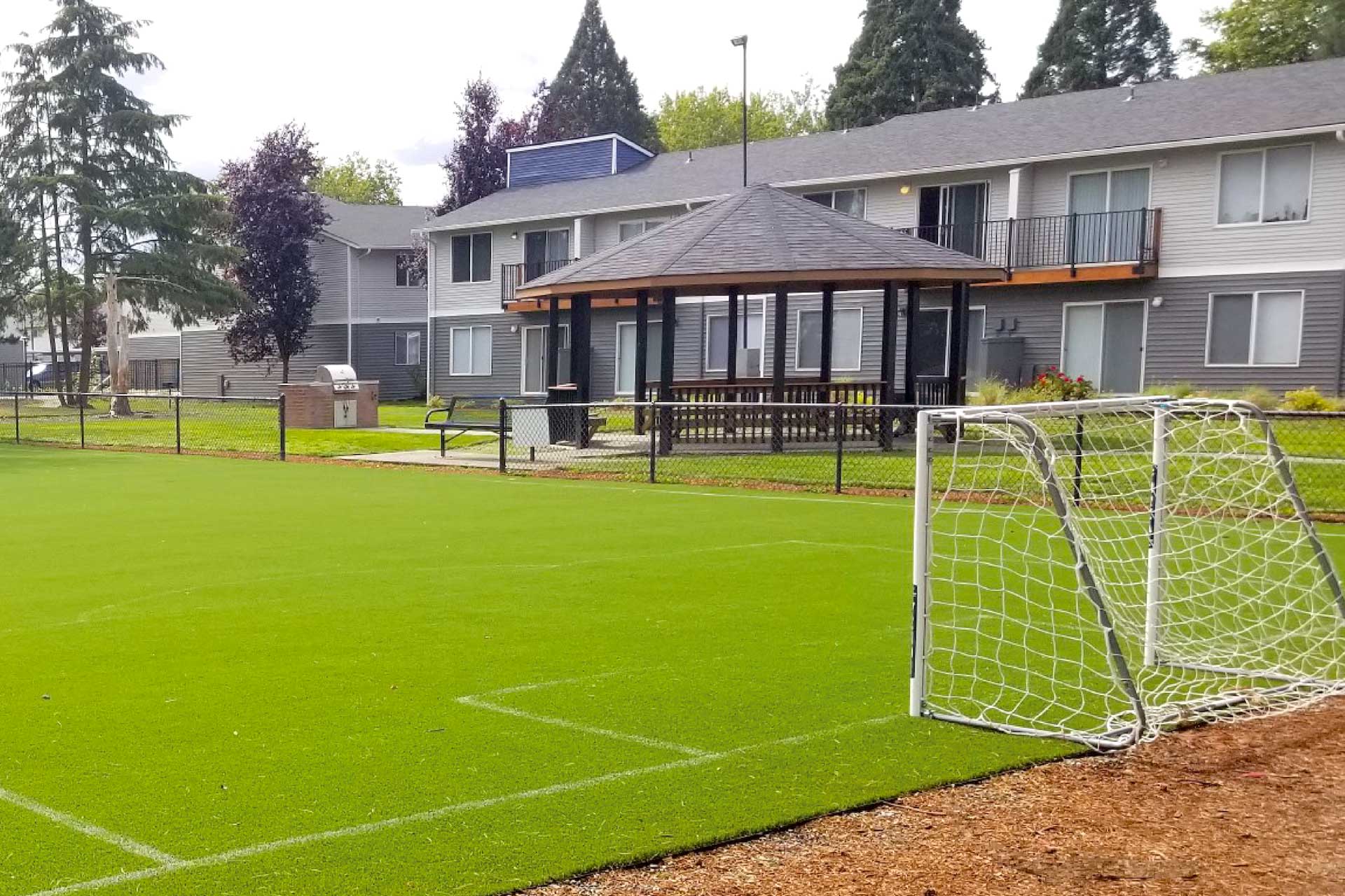 Soccer field with nearby apartments.